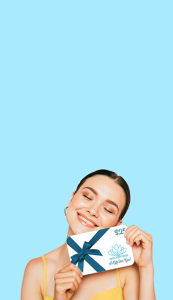 Smiling woman holding a Spa Mariana gift certificate.