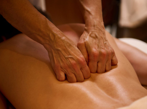 therapists doing deep tissue massage for client