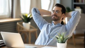 Employee relaxing at desk to support corporate wellness programs and employee burnout prevention