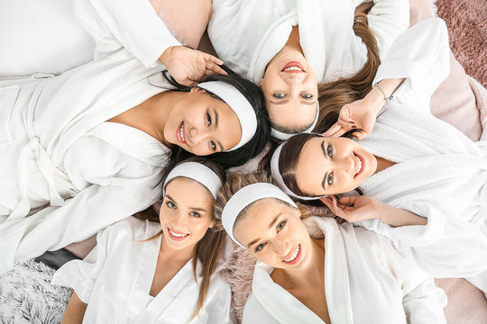 Bridal party in white robes enjoying a luxury spa day for wedding party before the ceremony